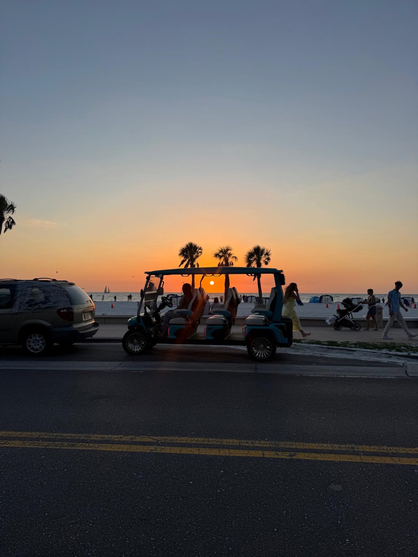 Sandy Golf Cart parked beachside at a Clearwater Beach sunset